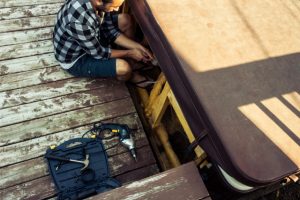 Hot Tub Maintenance by worker with his tools